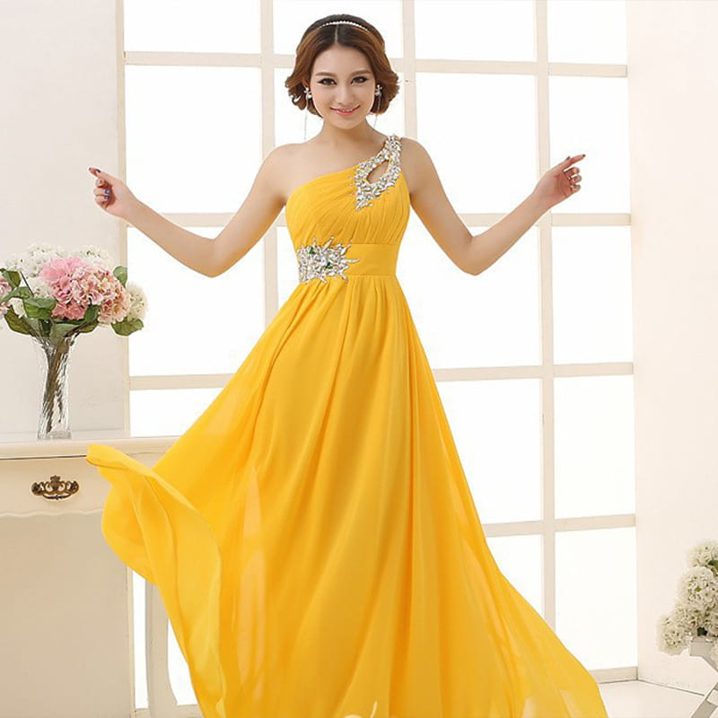 a vibrant yellow one-shoulder chiffon evening dress with a flowing skirt and sparkling silver beaded embellishments at the shoulder and waist suitable for dinner banquet long events