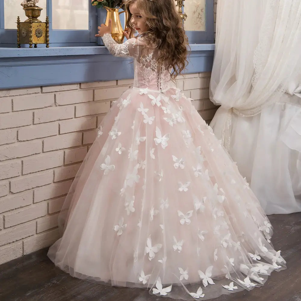 A delicate blush pink tulle girls pengpeng skirt featuring intricate white butterfly appliqués and a lace bodice in the pink butterfly lace girls pengpeng skirt.