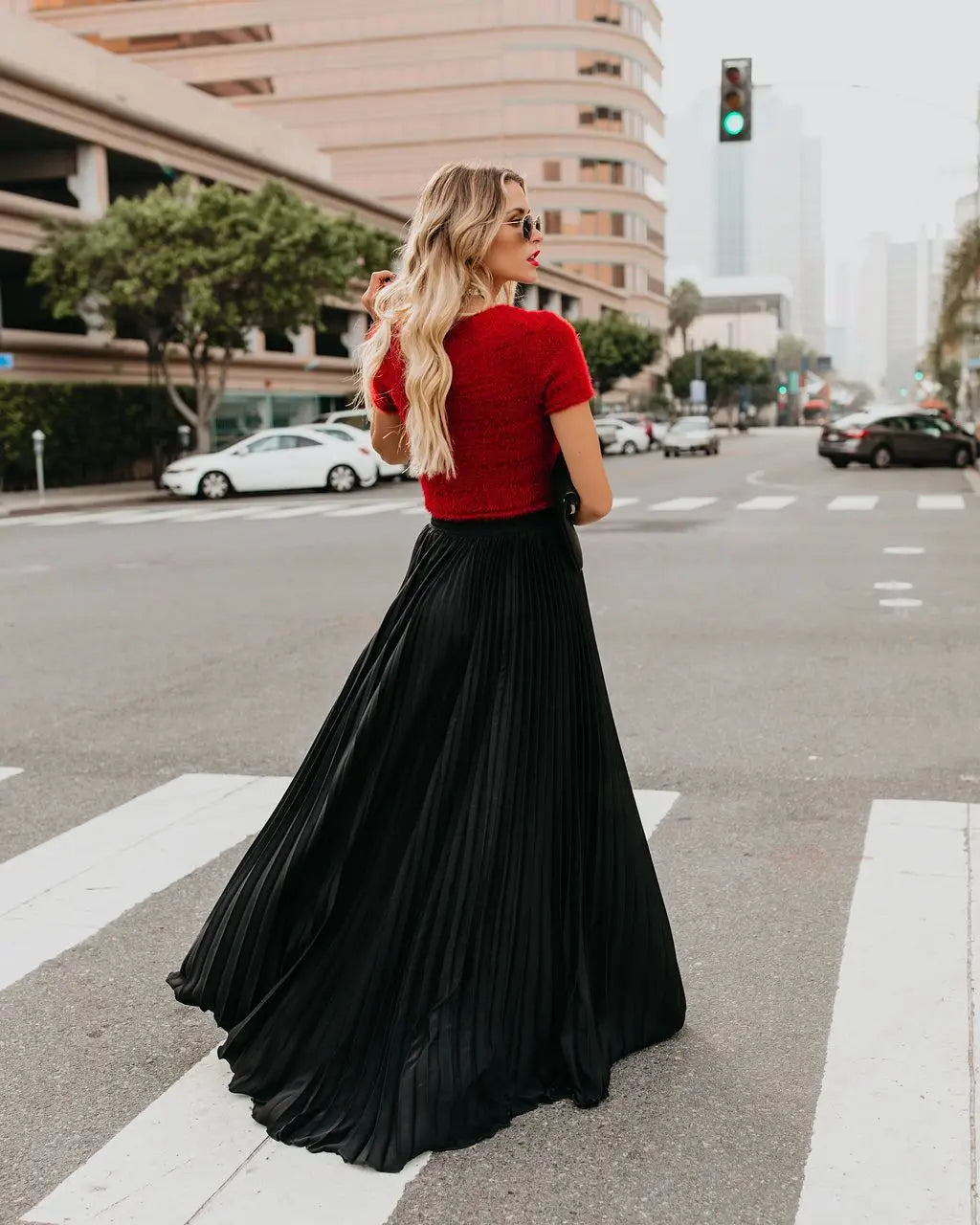 A flowing black pleated maxi skirt made of smooth lightweight fabric showcasing skirt length for women fashion casual wear.