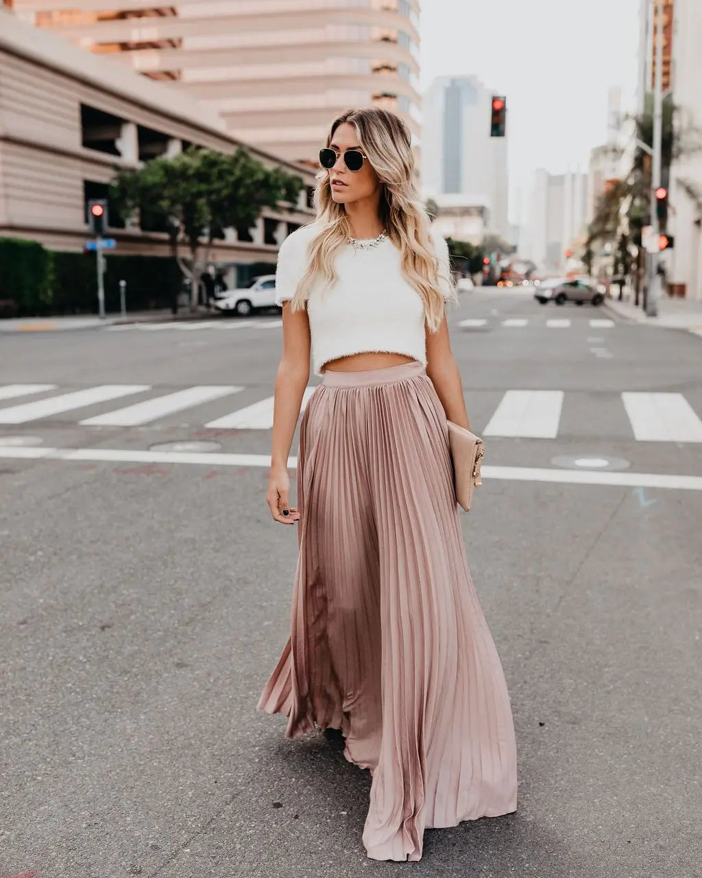 A flowing dusty rose pleated maxi skirt with a high waistband designed for women fashion casual wear showcasing skirt length and style.