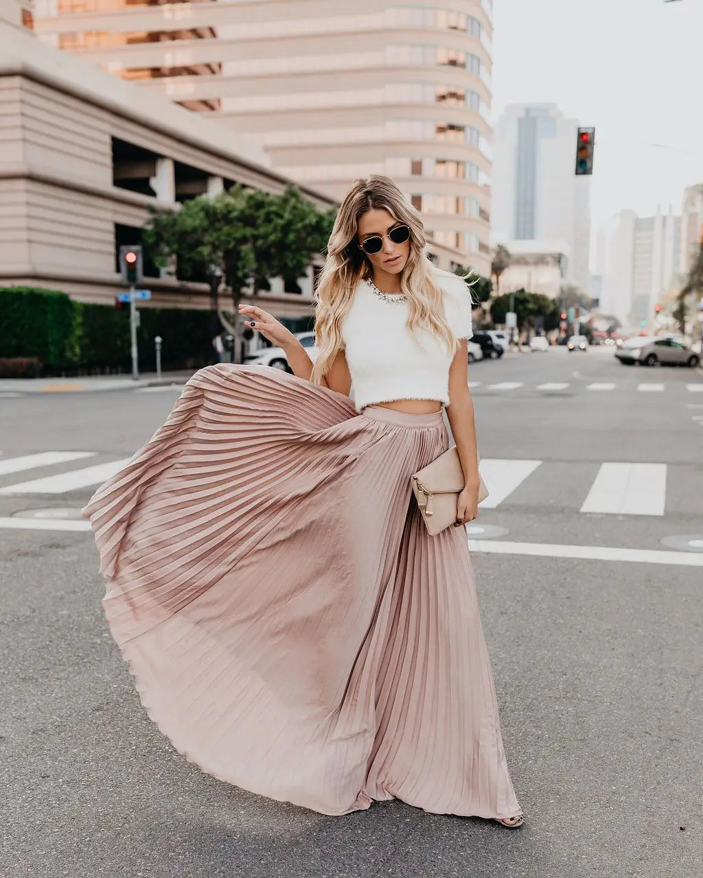 A flowing dusty rose pleated maxi skirt made of soft lightweight fabric designed as a red pleated high waist women fashion casual skirt.