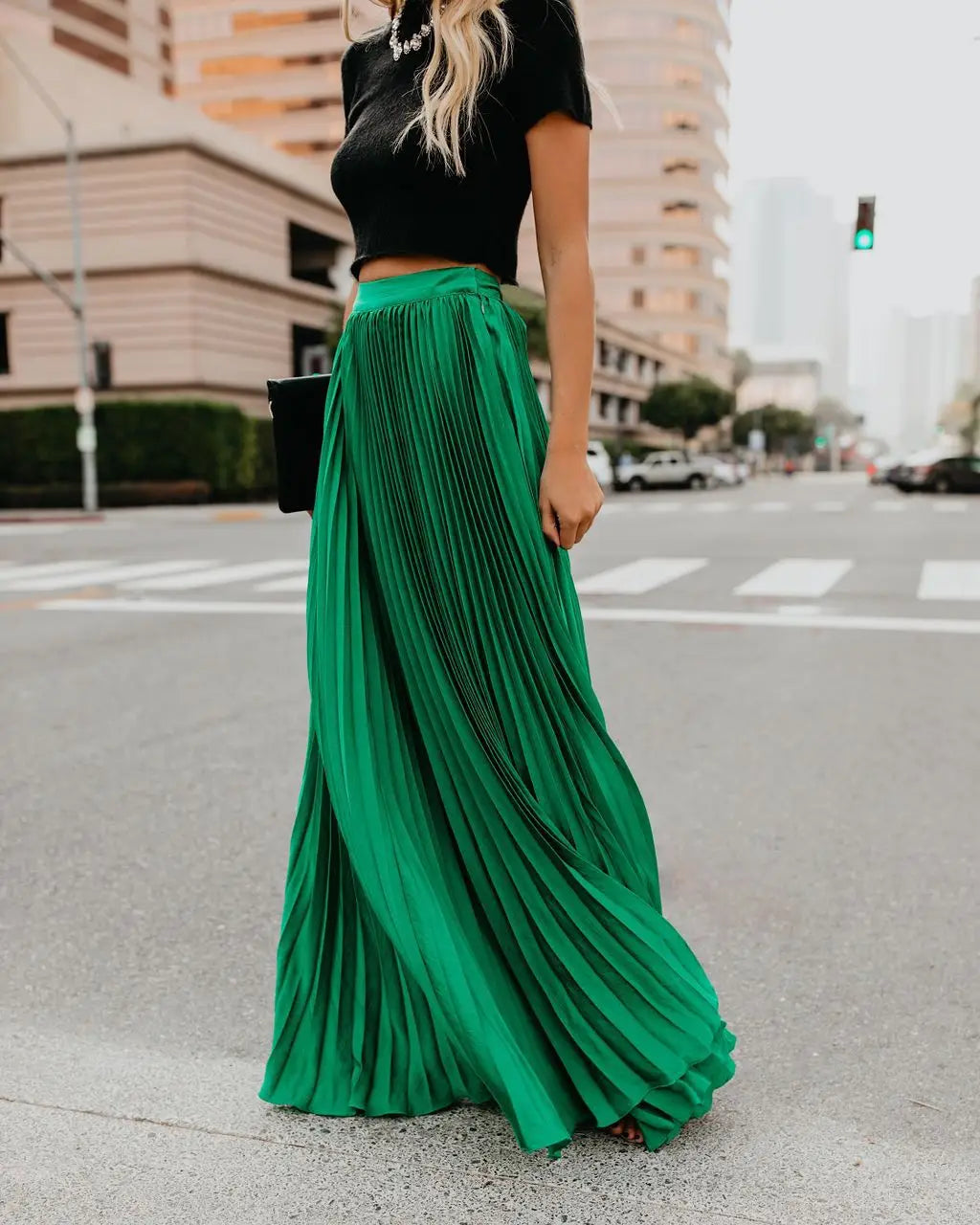 A flowing emerald green pleated maxi skirt with a high waistband showcasing women fashion casual style and skirt length suitable for a fashion casual skirt.