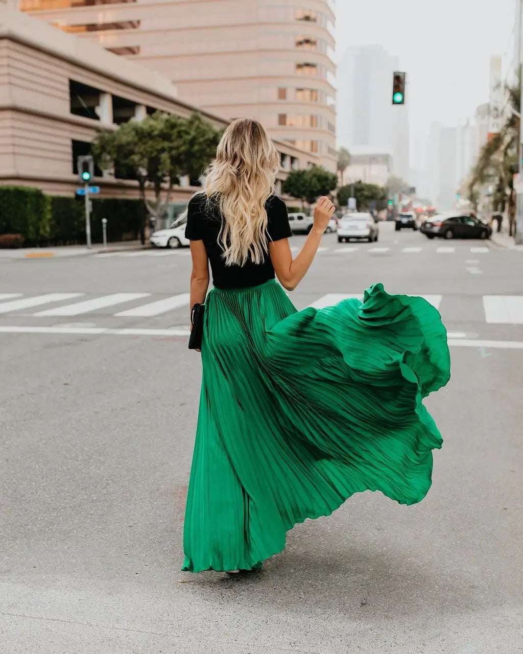 A flowing emerald green pleated maxi skirt showcasing skirt length and women fashion casual style as a fashion casual skirt.