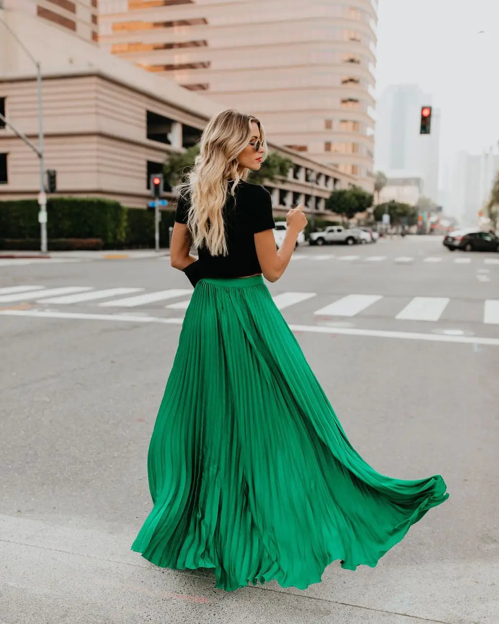 A flowing emerald green pleated maxi skirt showcasing skirt length and women fashion casual style for a fashion casual skirt.