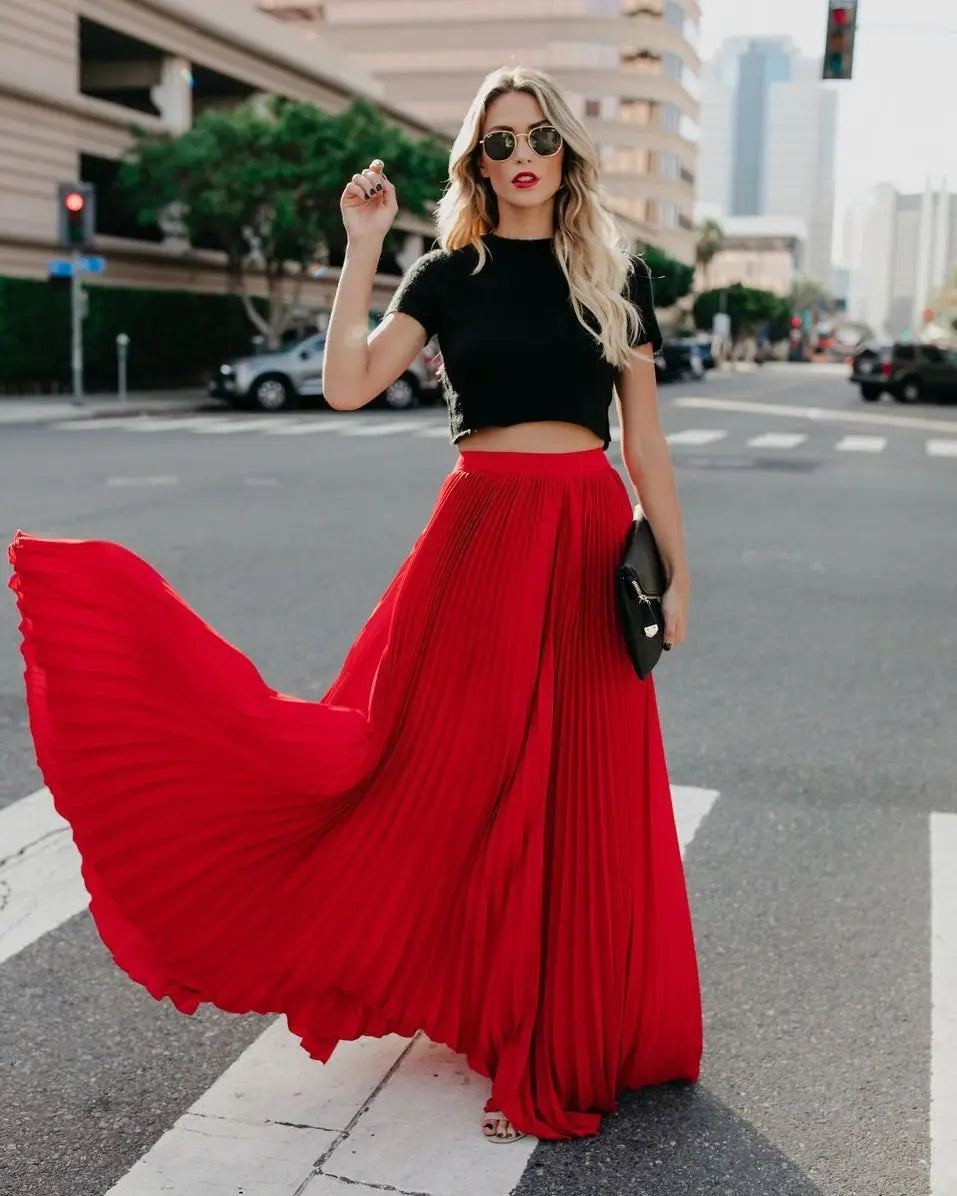 a vibrant red pleated maxi skirt featuring a flowing fabric and high waist design suitable for women fashion casual wear highlighting skirt length and style.