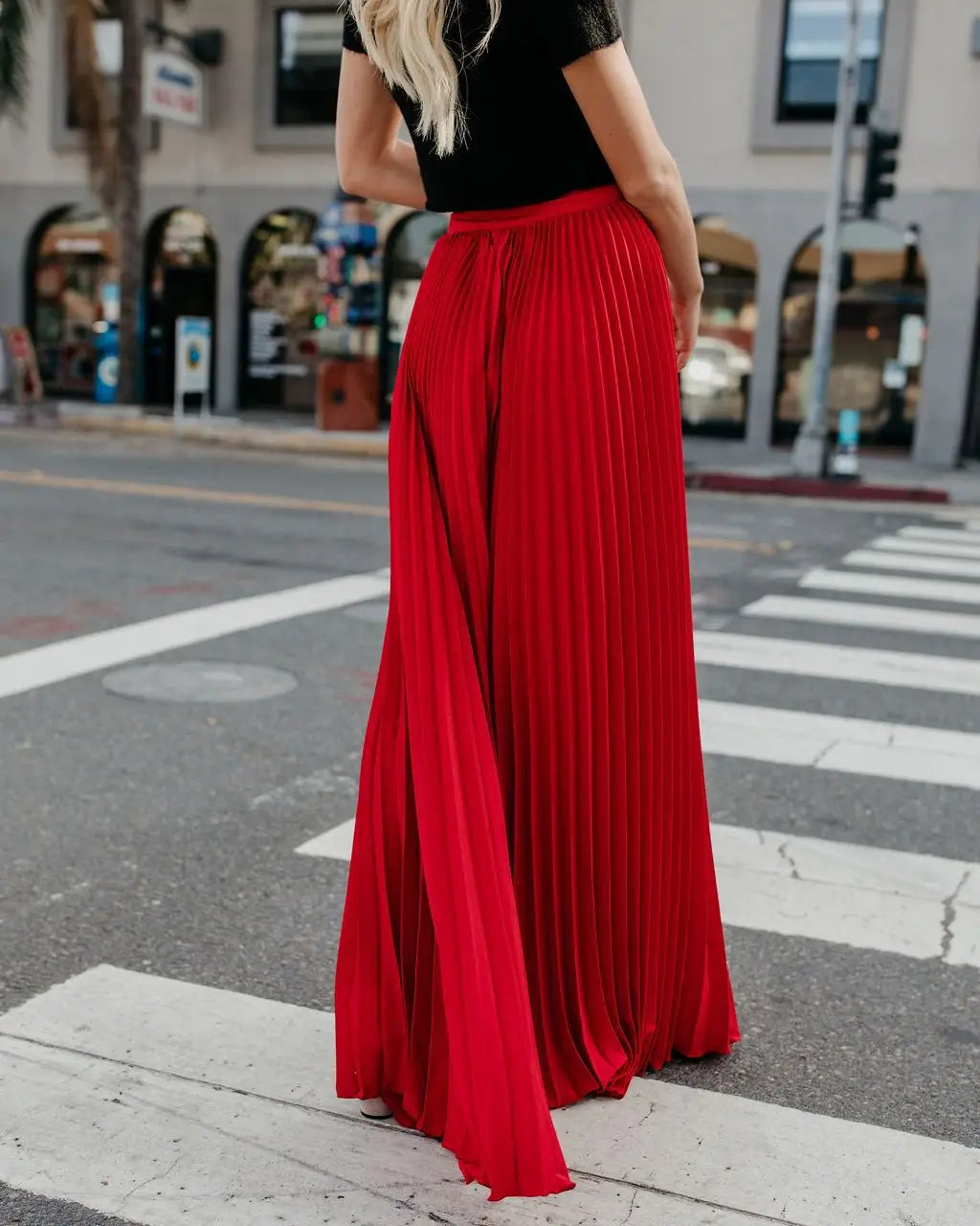 A vibrant red pleated high waist full-length maxi skirt with a flowing silhouette for women fashion casual wear.
