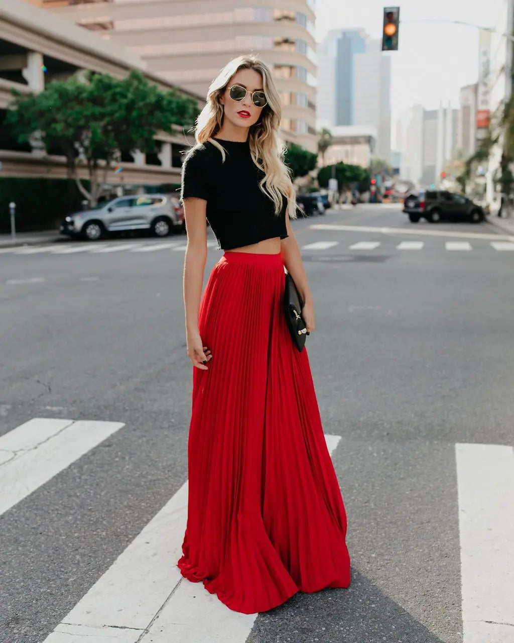A vibrant red pleated high waist women fashion casual skirt with a flowing floor-length skirt length.