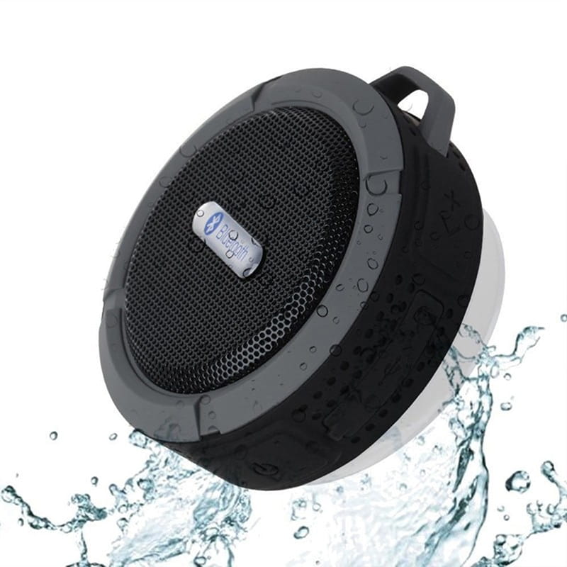 teal and black portable waterproof speaker with carabiner featuring a black textured grip handle and perforated grille ideal for outdoor use and luxury women’s fashion accessory trends.