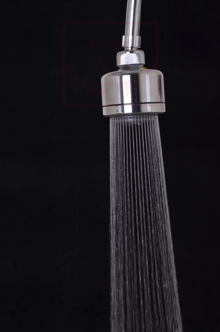 Chrome plastic small shower head in stainless steel with a sleek cylindrical design and multiple fine spray plastic small nozzles.