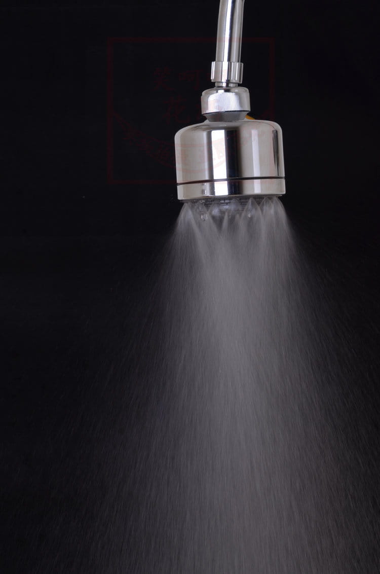 Chrome plastic small shower head with stainless steel finish, sleek cylindrical design, and adjustable spray pattern for versatile use.