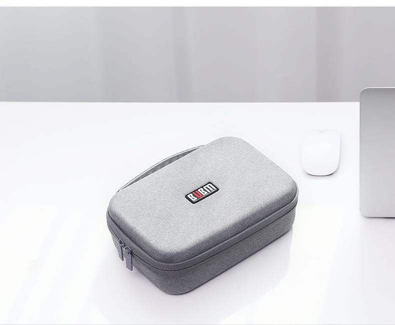 Gray textured hard-shell digital storage bag with a black and red Kurt logo patch designed as a travel organizer storage bag.