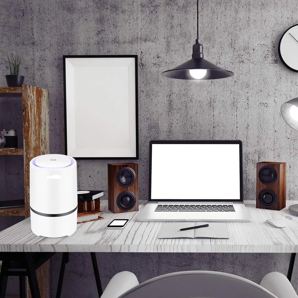 White minimalist usb air purifier with a cylindrical design, black accent band, and subtle glowing blue light at the top for effective air purifier air cleaning.