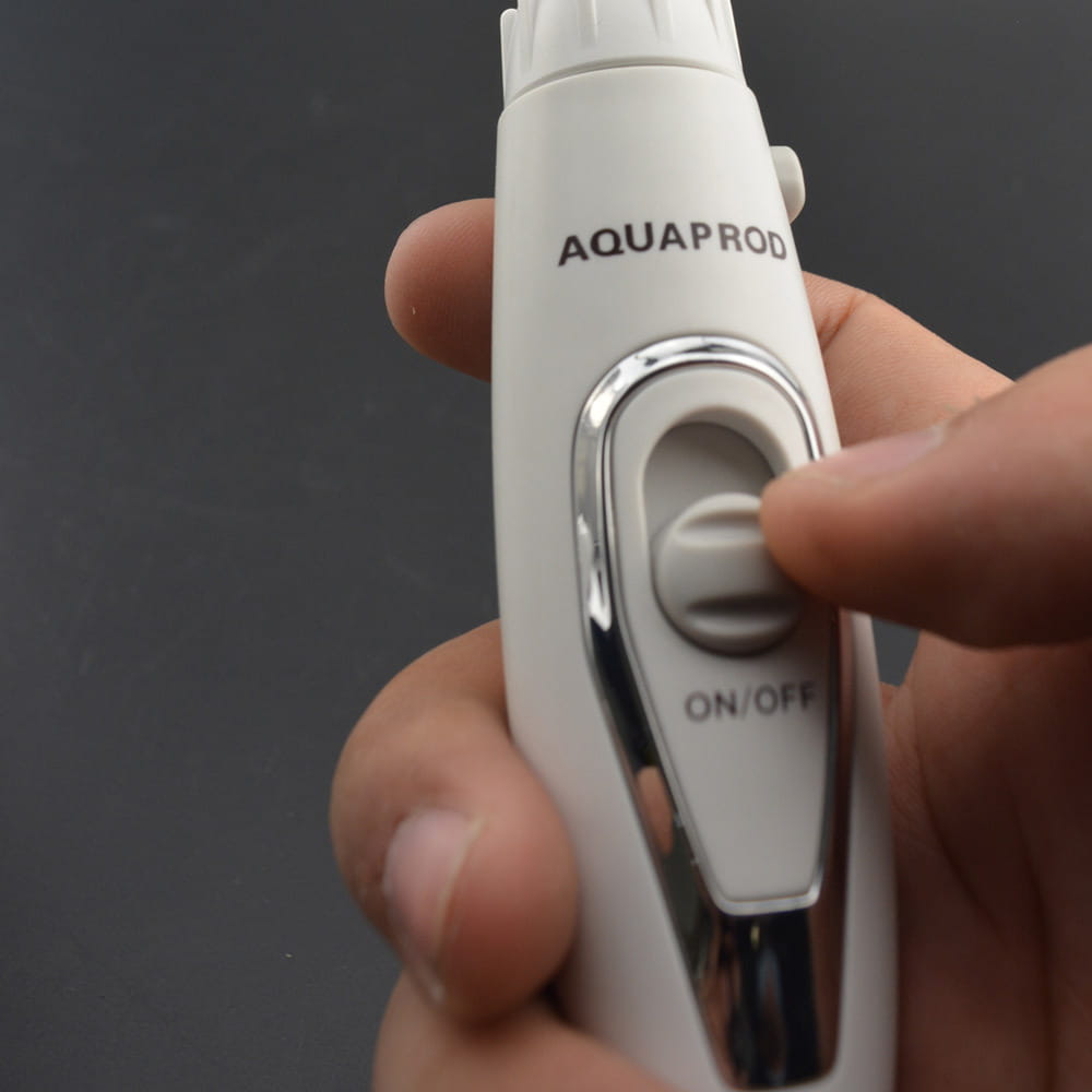 white aquaprod electric tooth punch with silver accent and on off button featuring a brush head and clear tank for modern electric tooth cleansing