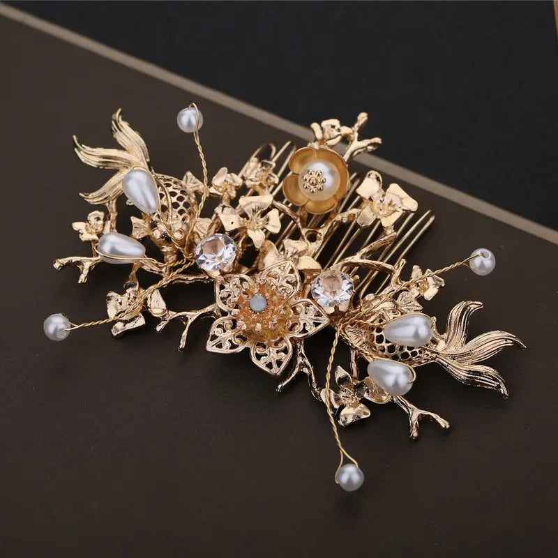 Elegant chinese bridal jewelry gold-toned floral hair comb adorned with pearls crystals and intricate metalwork.