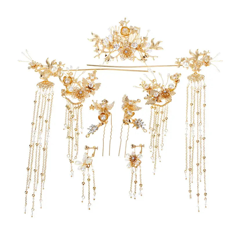 Elegant Chinese bridal jewelry gold-colored ornate hair accessories set with intricate floral and bird designs adorned with pearls crystals and dangling chain tassels.