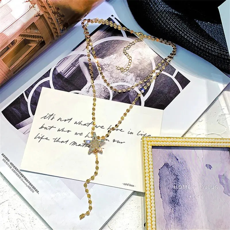 Gold-toned chain necklace featuring a sparkling star pendant with embedded crystals designed as a variable mso-font-signature accessory.