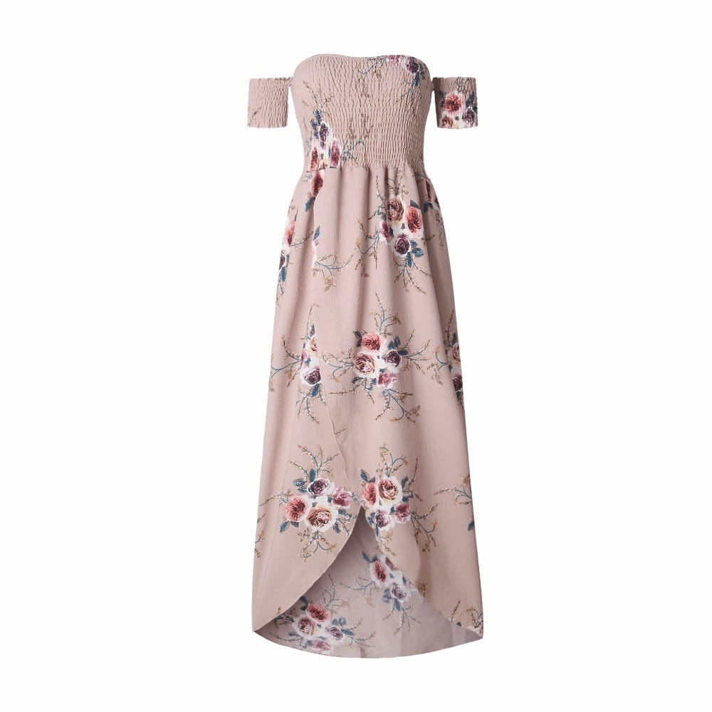 A soft blush pink boho style long dress women with an off shoulder design, smocked bodice, and muted pink, purple, and green floral pattern.
