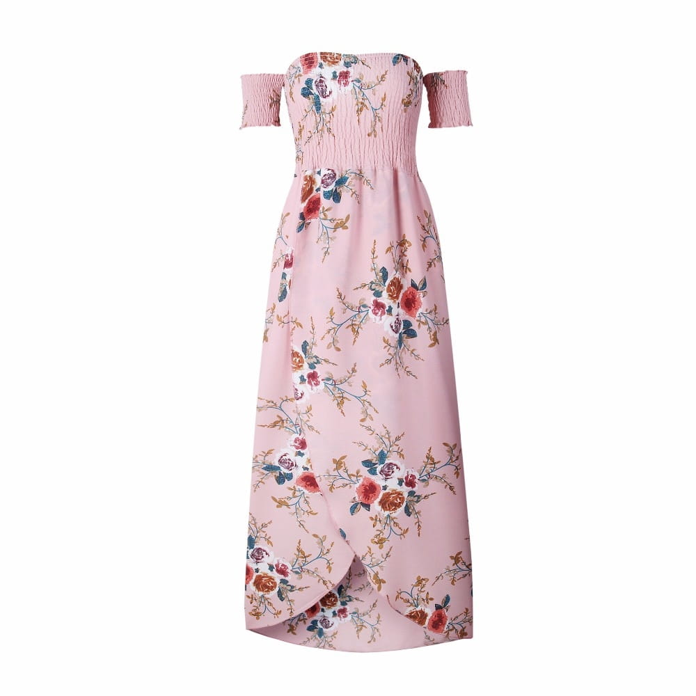 A soft pink boho style long dress women off the shoulder maxi with a delicate floral pattern of red orange and blue blossoms on light fabric.