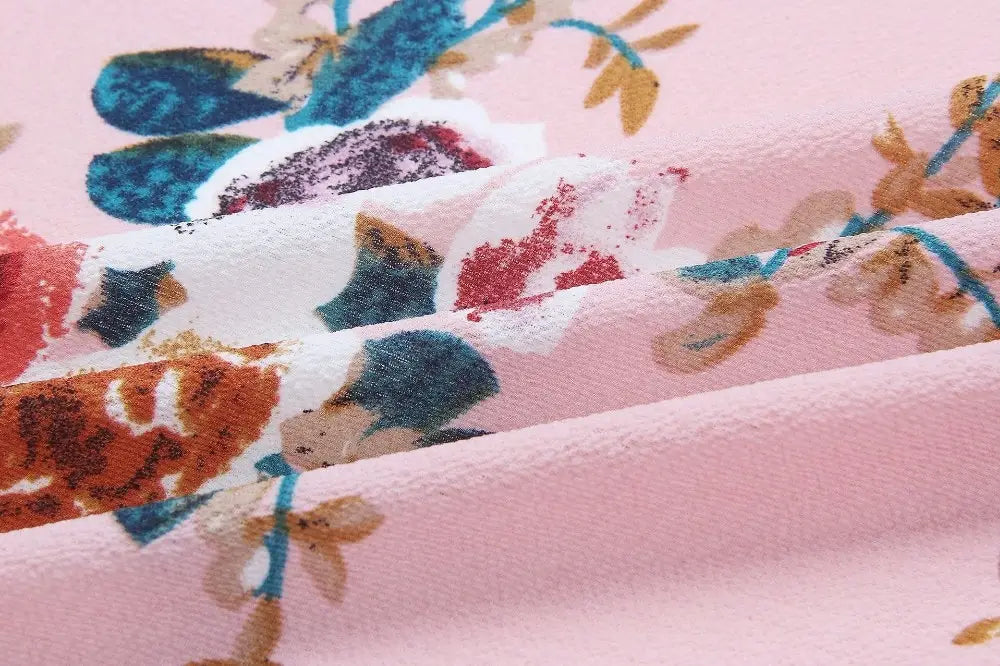 boho style long dress women floral off shoulder maxi featuring pink fabric with a soft textured surface and vibrant blue orange and brown blossoms on white petals