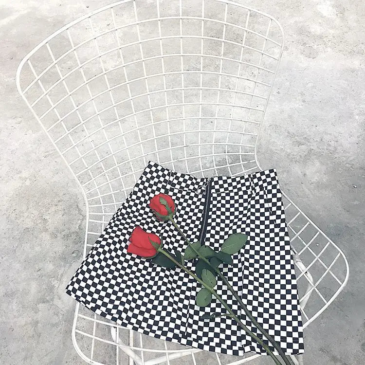 black and white checkered mini skirt with a central zipper featuring mso-font-pitch variable mso-font-signature design details