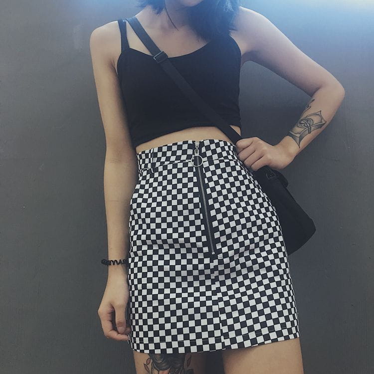 Black and white checkered mini skirt featuring a front zipper closure designed with mso-font-pitch variable mso-font-signature for a stylish look.