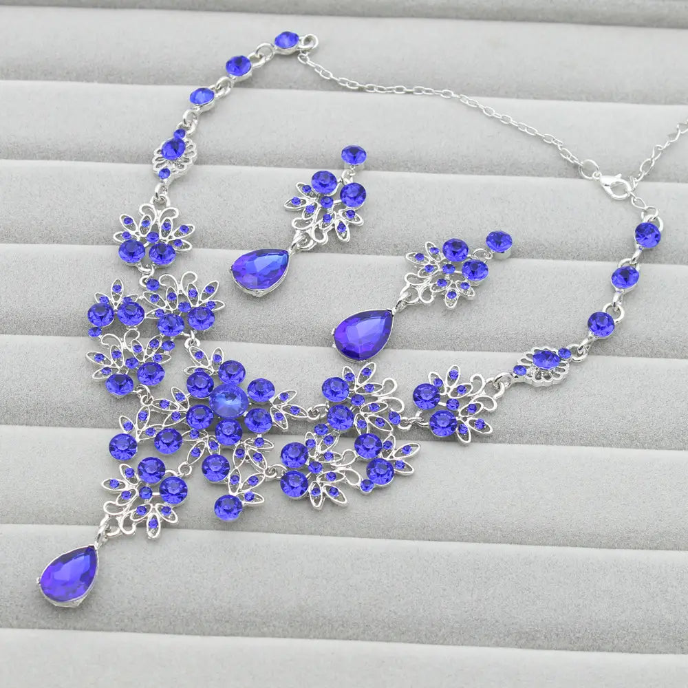Elegant royal blue crystal butterfly big water drop necklace and earring set with silver-toned metalwork featuring floral design and matching teardrop earrings.