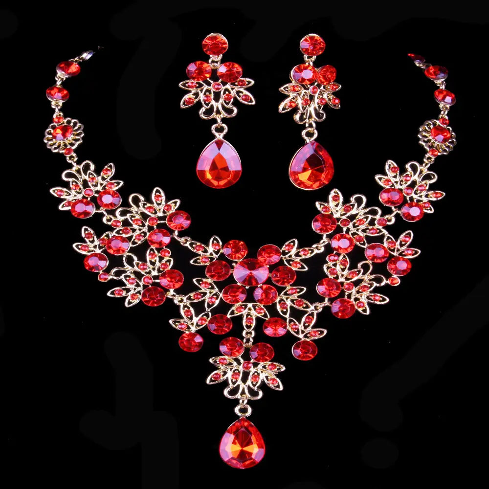 Elegant red crystal earring set with gold-toned floral filigree and butterfly big water drop teardrop pendants.