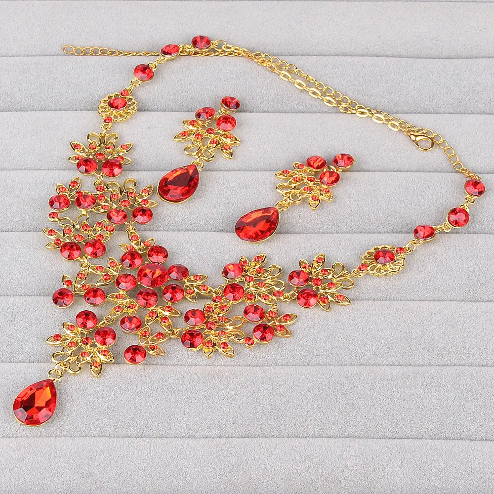 Elegant gold-toned butterfly big water drop earring set featuring vibrant red crystals in a floral design.
