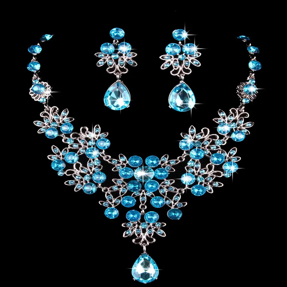 Elegant blue crystal butterfly big water drop necklace earring set featuring silver-toned floral designs and teardrop-shaped pendants.