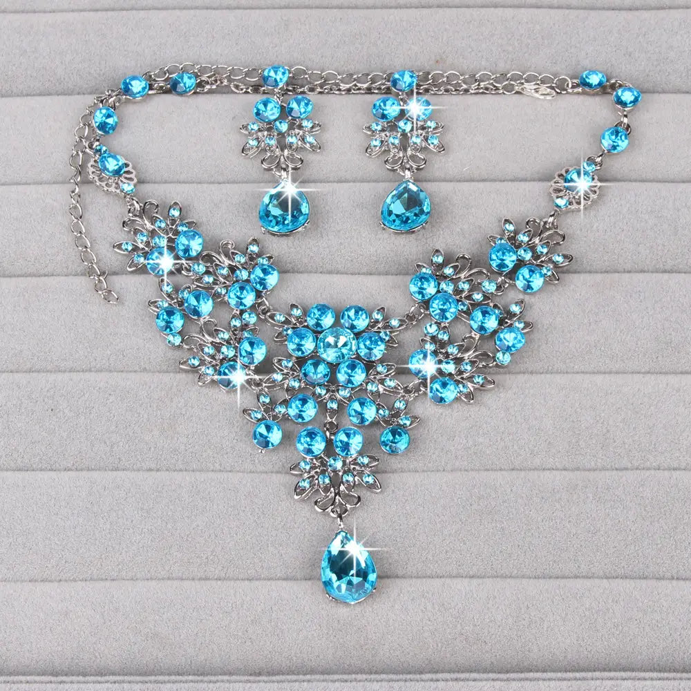 Elegant blue crystal butterfly big water drop necklace earring set featuring a silver-toned floral design with teardrop pendants.