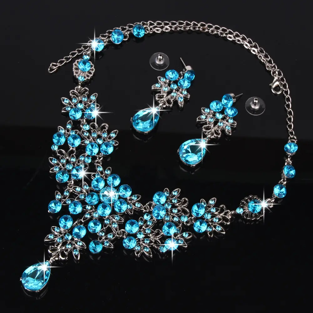 a sparkling blue crystal necklace with silver-toned floral and leaf designs accented by teardrop-shaped crystals from the butterfly big water drop crystal earring set