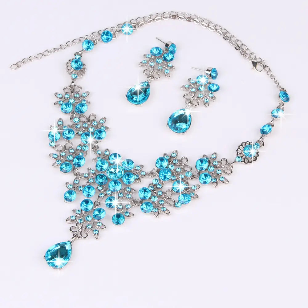 a sparkling blue crystal butterfly big water drop necklace and earring set featuring silver-toned floral and leaf designs with a large teardrop pendant