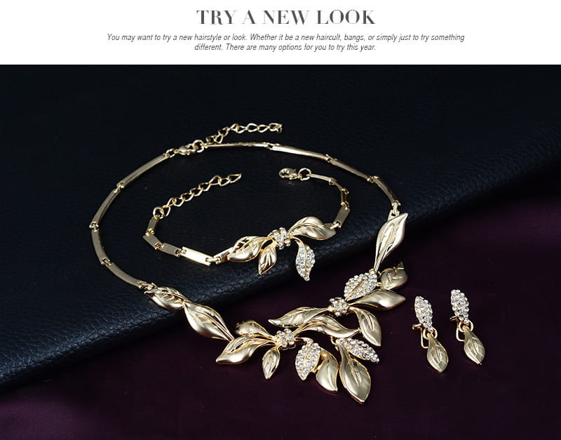 gold-toned leaf-themed bridal wedding jewelry set featuring intricate metalwork and sparkling crystal accents ideal for weddings.