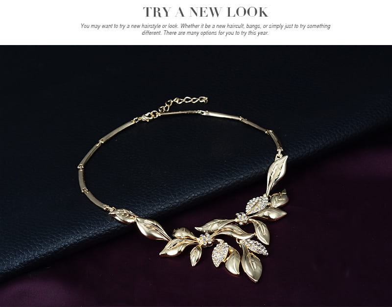 Gold-toned leaf and crystal embellished necklace with a delicate chain from a bridal wedding jewelry set designed for weddings.