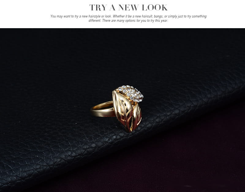 Gold leaf-shaped gold ring adorned with sparkling clear stones as part of a bridal wedding jewelry set.
