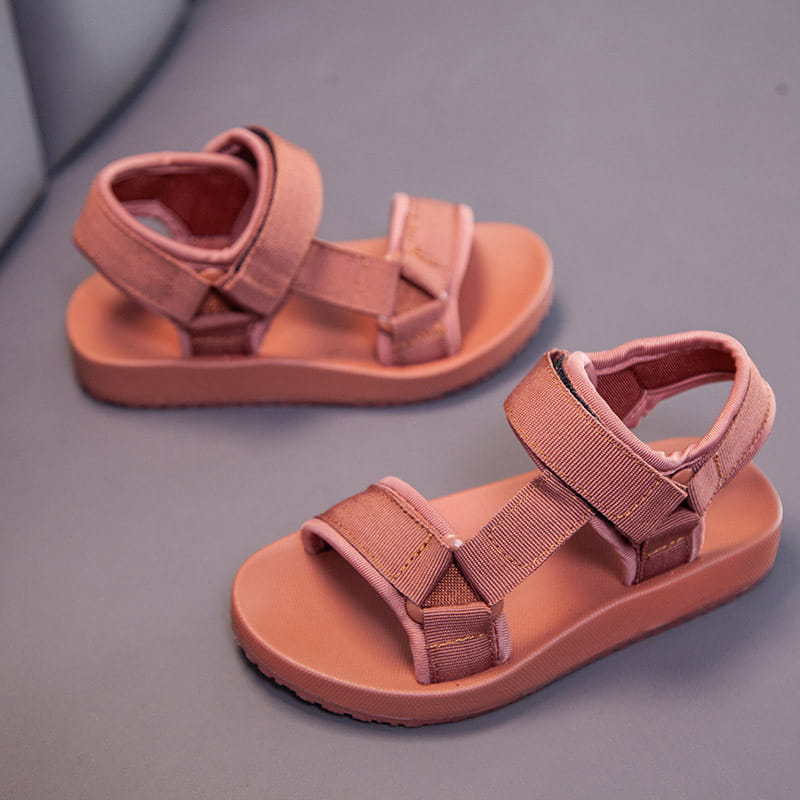 Pair of dusty rose-colored childrens peach breathable casual shoes with adjustable velcro straps and soft rubber sole designed as school breathable casual shoes.