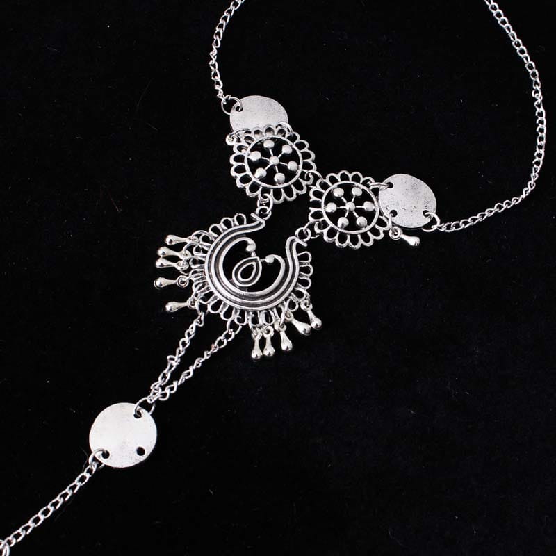silver-toned bohemian jewelry antique foot chain featuring intricate filigree designs, dangling coin charms, and delicate antique silver color chain links.