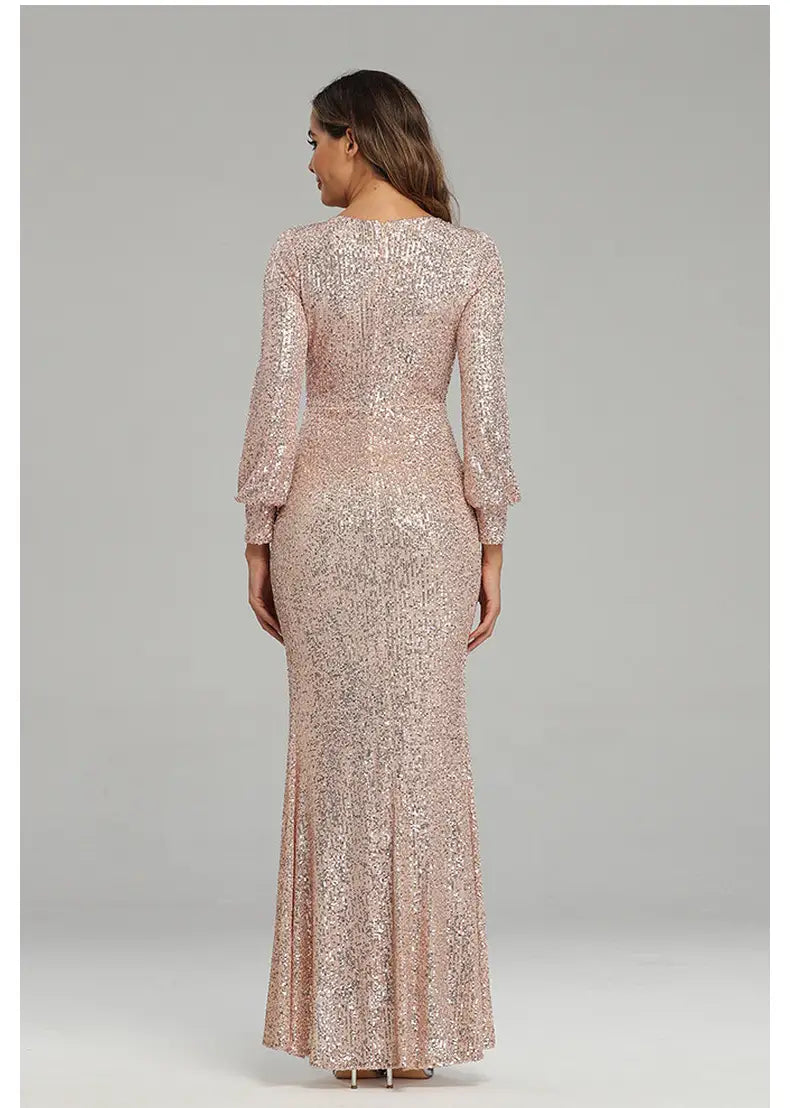 A shimmering rose gold sequined floor-length fantasy celebrity sexy high slit evening dress with long sleeves and a fitted silhouette.