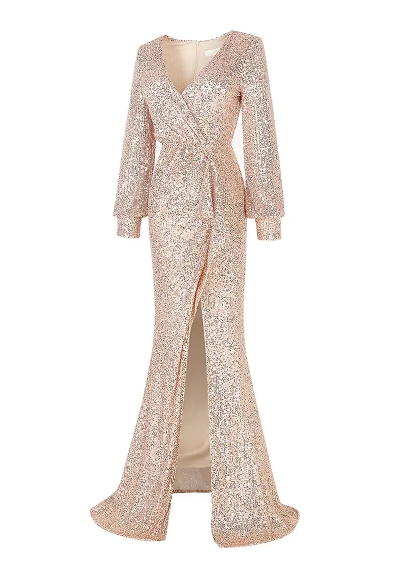 A shimmering rose gold sequined fantasy celebrity sexy evening dress featuring a v-neckline, long sleeves, a fitted silhouette, and a sexy high slit.
