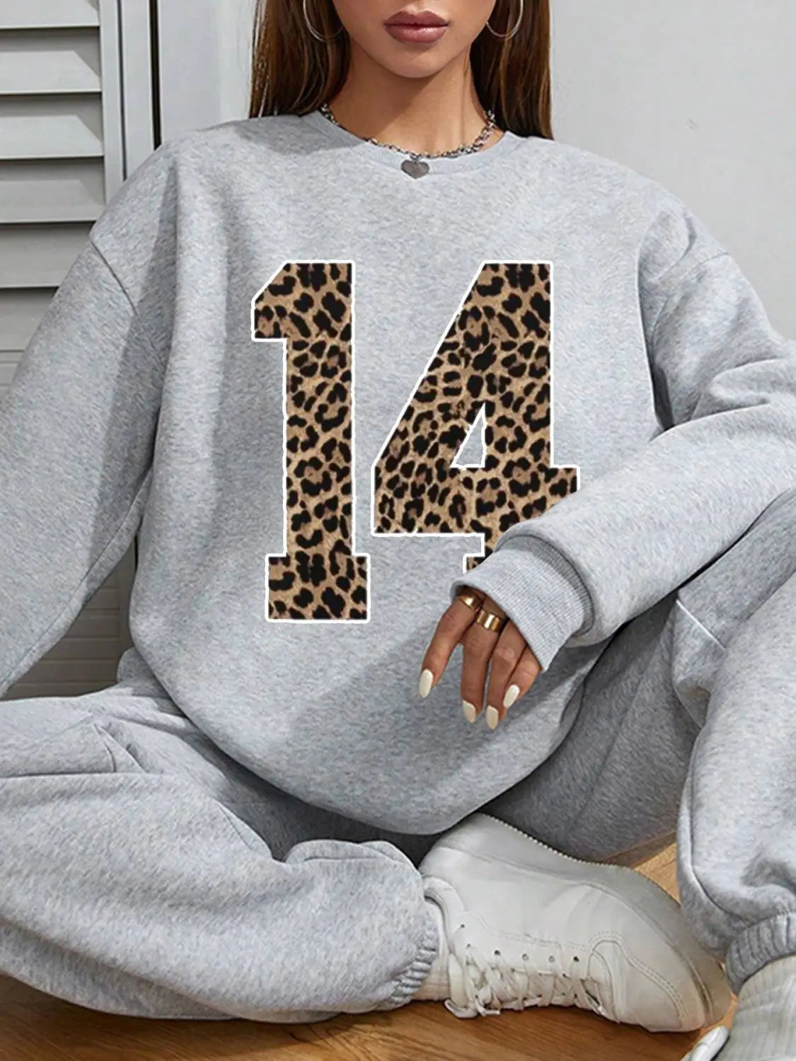 gray crew neck sweatshirt featuring a bold black leopard print number 14 across the chest