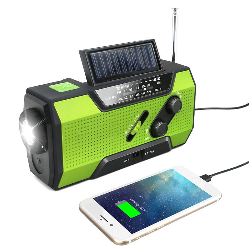 Green and black hand crank solar radio with built-in flashlight and USB charging port for emergency use.