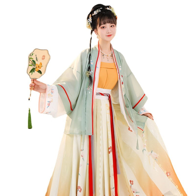 A woman wears a delicate layered han chinese clothing ensemble in soft mint green and cream with subtle floral embroidery showcasing a clothing summer improvement design.