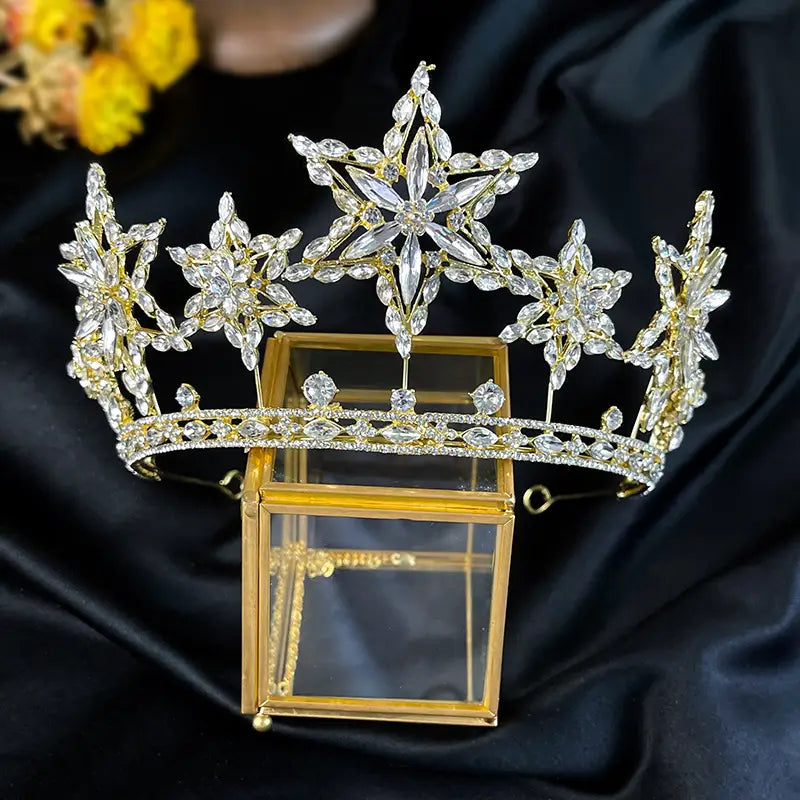 a sparkling gold tiara crown adorned with intricate star-shaped crystal motifs and delicate floral designs from xingx rhinestone fashion accessories xingx rhinestone.