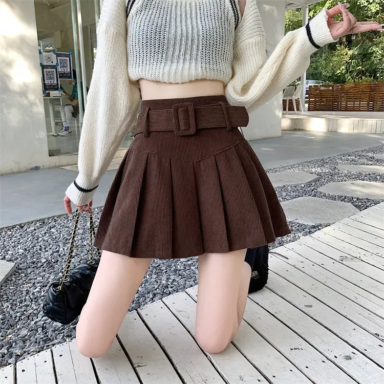 brown corduroy half skirt pleated mini with a matching belt featuring a rectangular buckle.