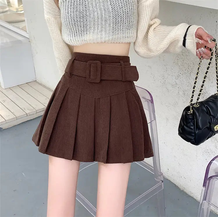 Brown corduroy half skirt pleated mini with a matching belt featuring a rectangular buckle.