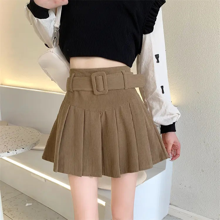 Tan corduroy half skirt pleated mini with a matching brown belted corduroy skirt pleated skirt featuring a rectangular buckle.