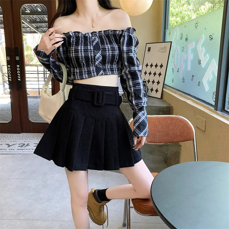 black pleated skirt with a wide brown corduroy belt featuring a large rectangular buckle in a corduroy half pleated skirt pleated mini style.