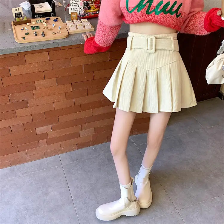 cream-colored corduroy half skirt pleated mini with a matching brown belted skirt pleated skirt design.