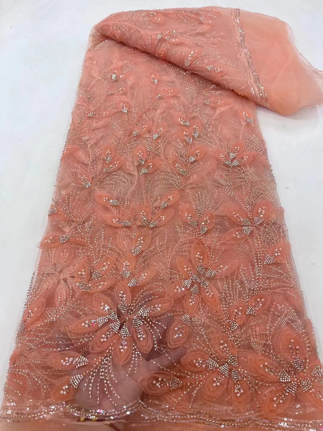 Peach ribbon flower beaded tulle lace fabric featuring delicate lace material with intricate floral embroidery and sparkling rhinestones.