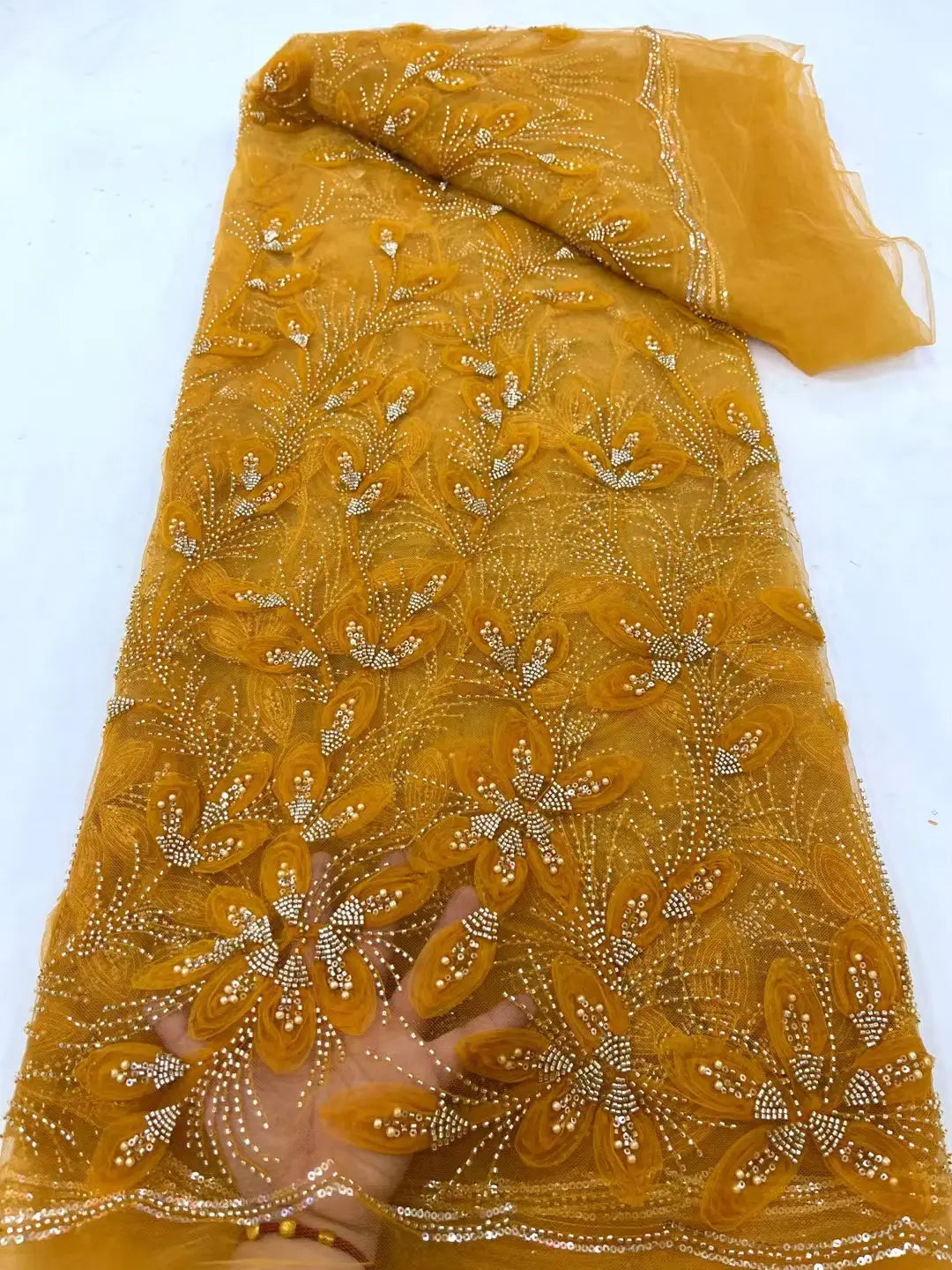 golden sheer lace fabric featuring intricate floral embroidery with ribbon flower beaded accents on delicate flower beaded tulle lace perfect for elegant garment design.